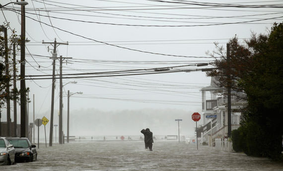 man wades through a street flooded during Hurricane Sandy in Ocean City, Maryland, on October 29, 2012. (Reuters/Kevin Lamarque)