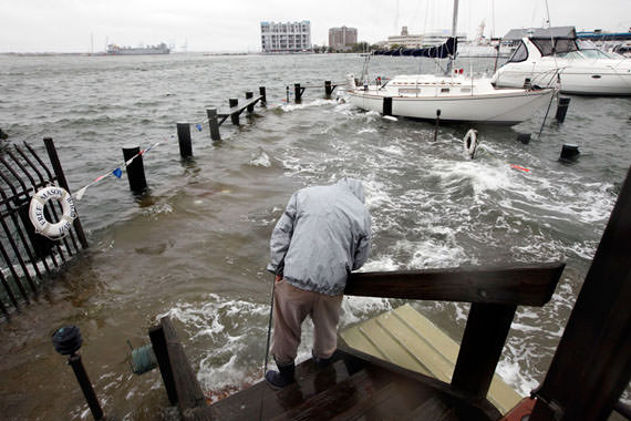 Norfolk resident Jack Devnew looks at the water covering a dock as he checks on his boat at a marina near downtown Norfolk, Virginia, on October 29, 2012. (AP Photo/Steve Helber)