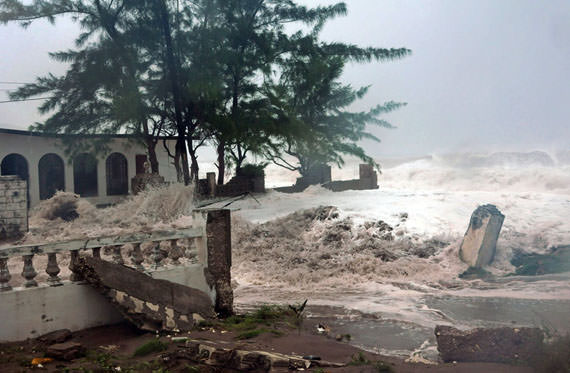 Waves, brought by Hurricane Sandy, crash on a house in the Caribbean Terrace neighborhood in eastern Kingston, Jamaica, on October 24, 2012. (AP Photo/Collin Reid)